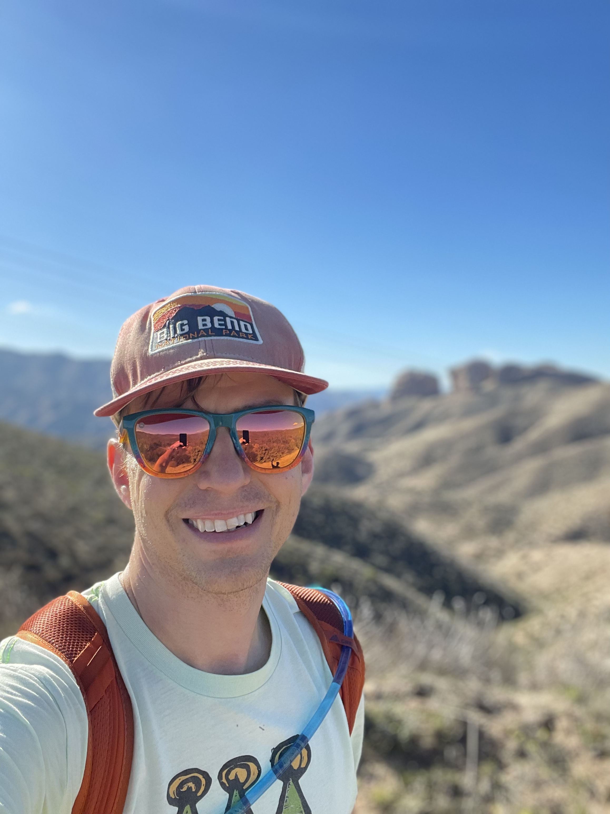 A headshot of the author in the mountains